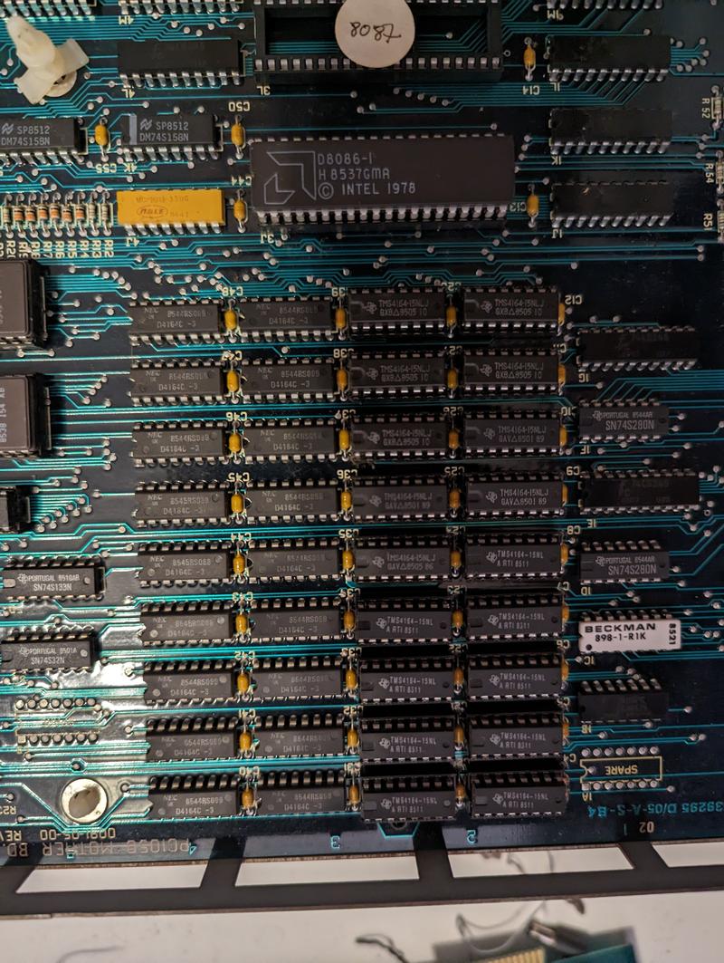 Photo of a section of the motherboard. Many socketed chips are seen, with a few resistors and other analog components here and there. Chips are described above.