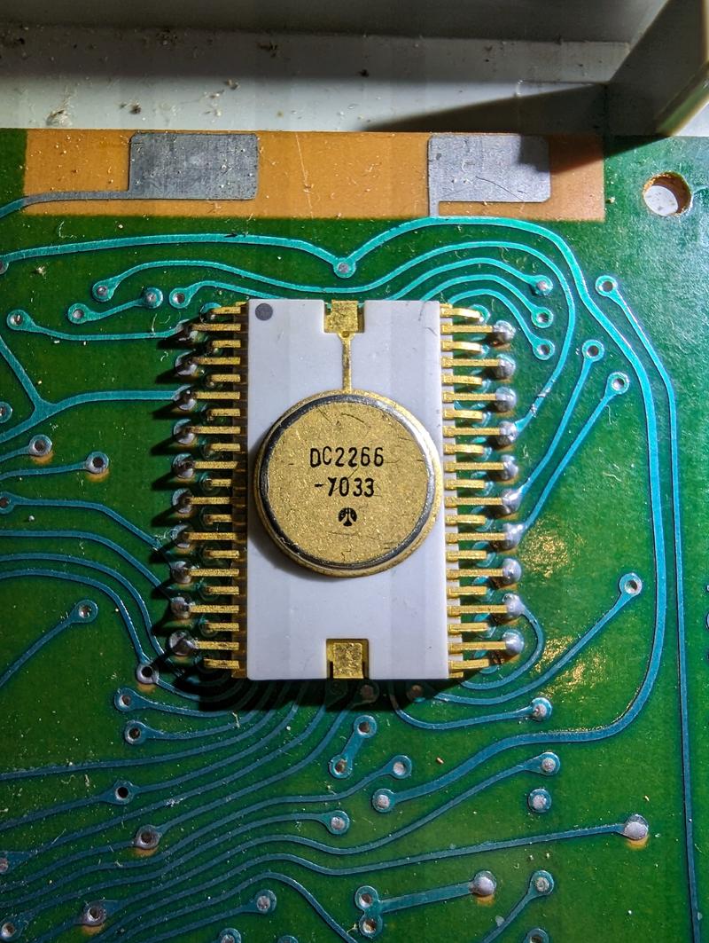 Close-up of one of the LSI chips, showing the white ceramic package and the pins.